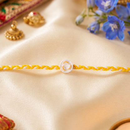 White Round Charm Fancy Dori Rakhi tied on wrist