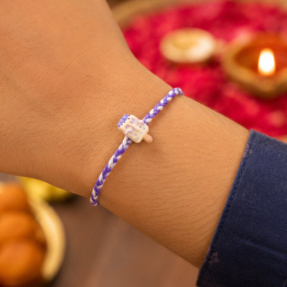 Designer rakhi showing festive dori detail