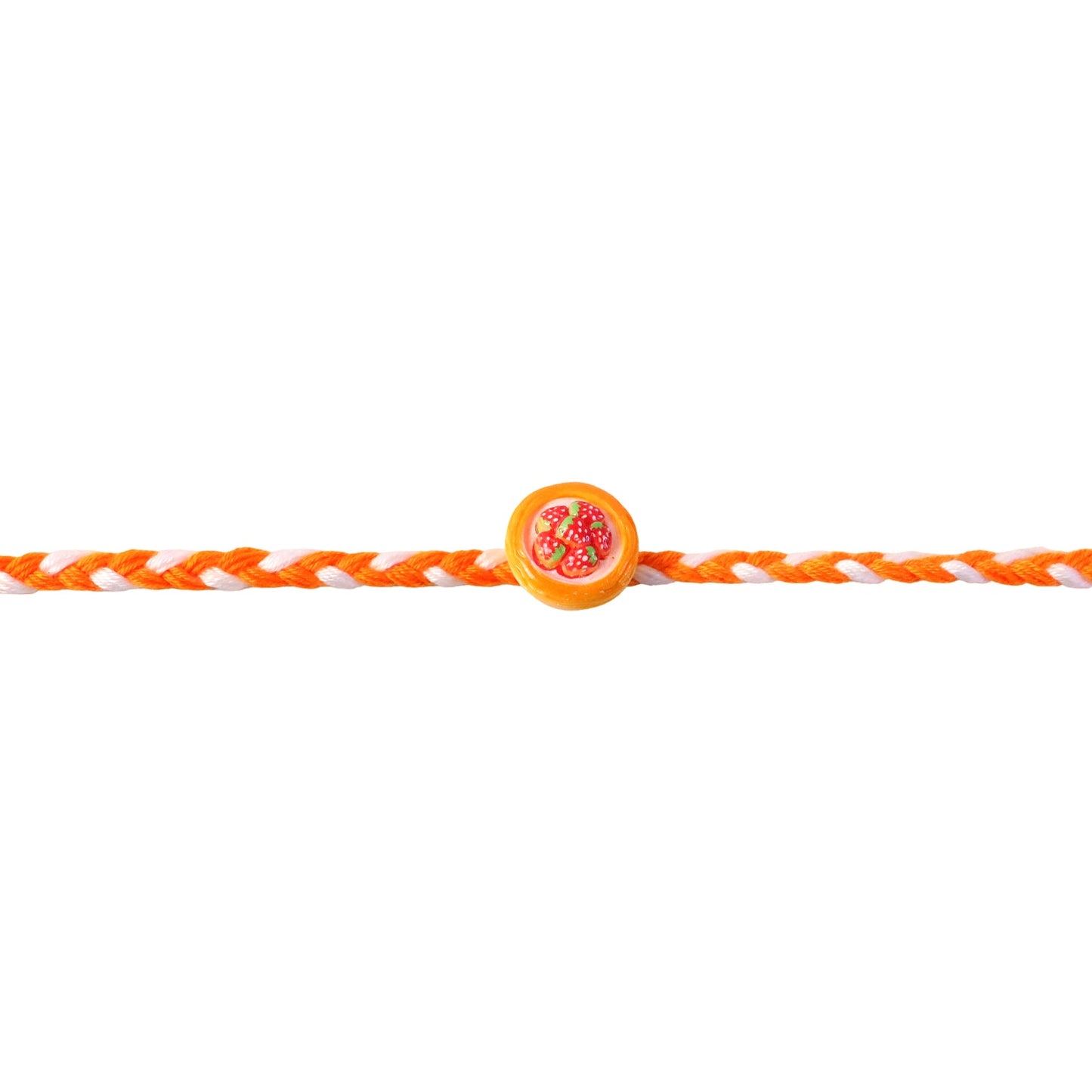 Hand holding the strawberry dessert dori rakhi