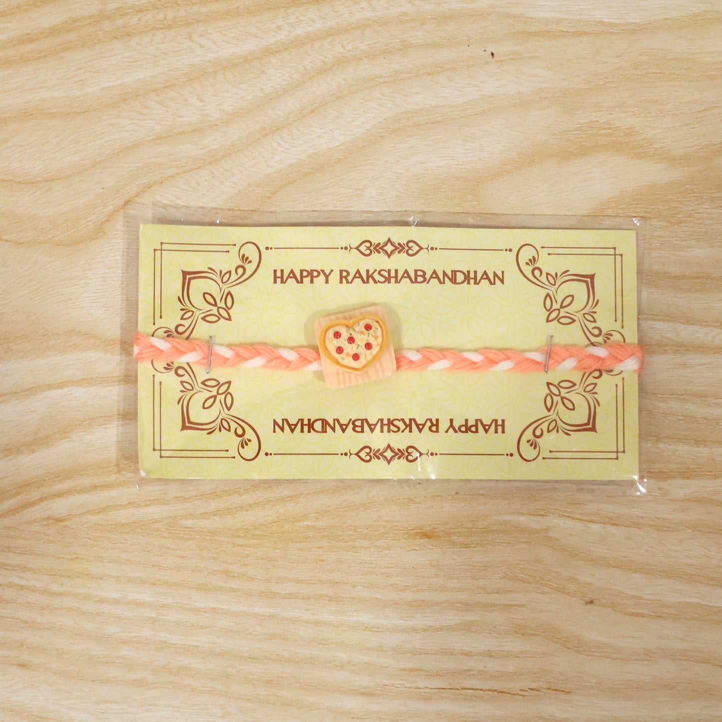 Detailed view of designer rakhi's heart pizza charm