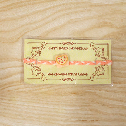 Detailed view of designer rakhi's heart pizza charm