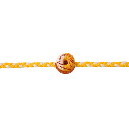 Donut charm rakhi on white background