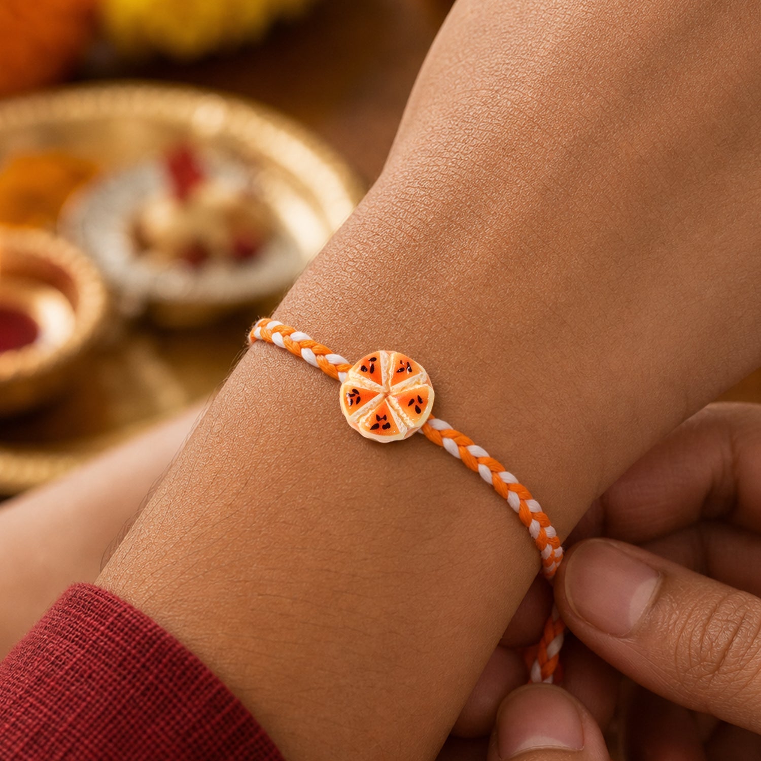 Orange Slice Charm Rakhi close-up detail