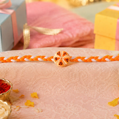 Orange Slice Charm Rakhi showing thread and charm