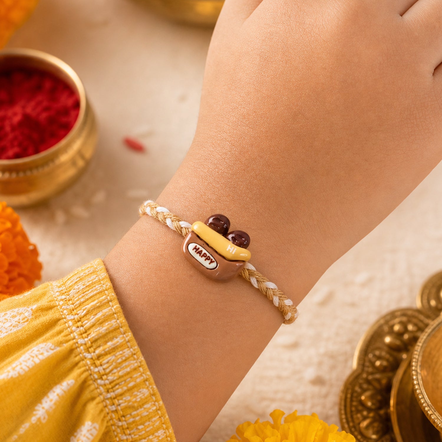 Close-up of Happy Cup Charm Fancy Dori Rakhi showing detailed design