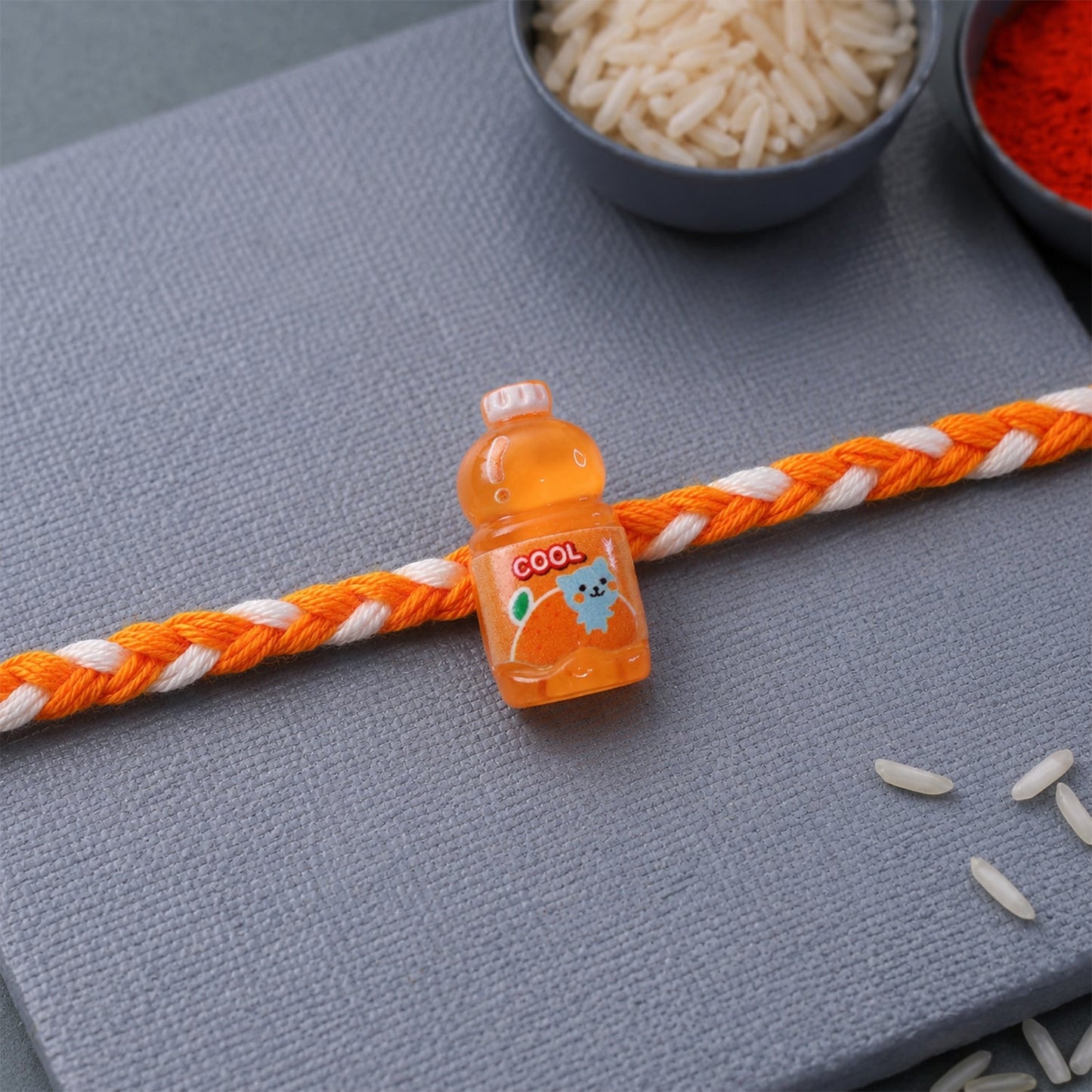 Side view of fancy drink bottle charm rakhi display