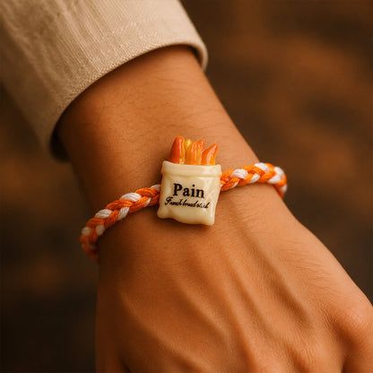 Designer rakhi with food-themed charm on dori thread