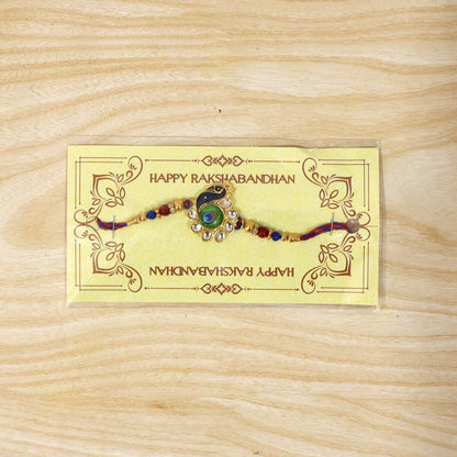 Peacock Feather charm rakhi displayed clearly on white background