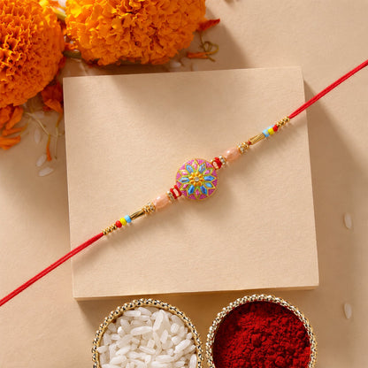 Close up of colorful meenakari charm on rakhi with beads