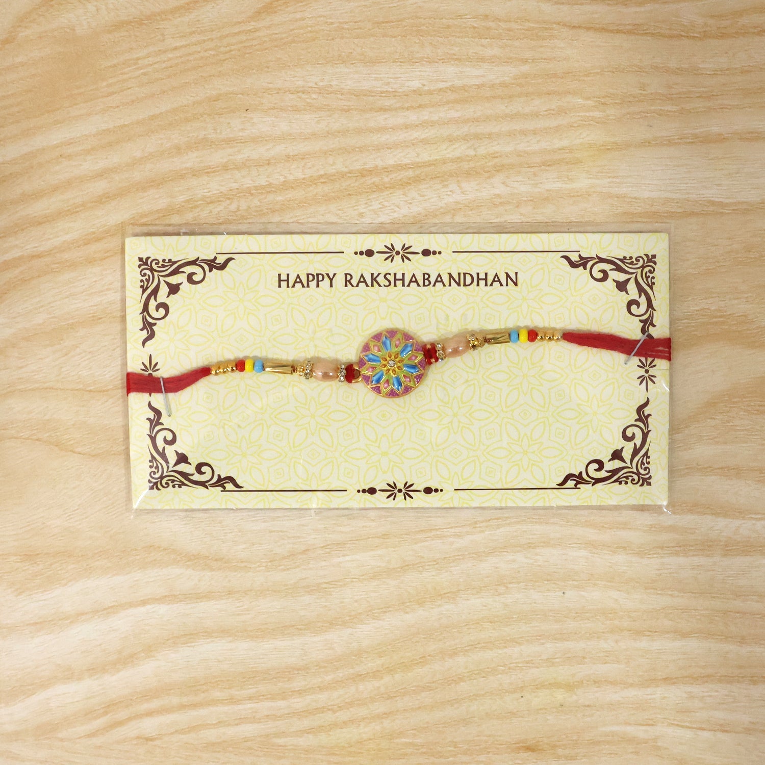 Elegant designer rakhi featuring meenakari charm and beads