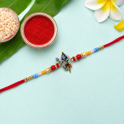 Close-up of designer rakhi with Mahadev idol and beads