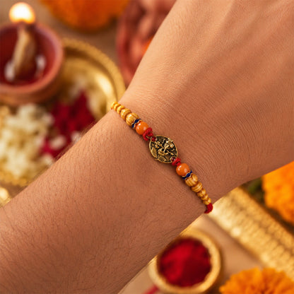 Designer rakhi with wooden beads and divine charm