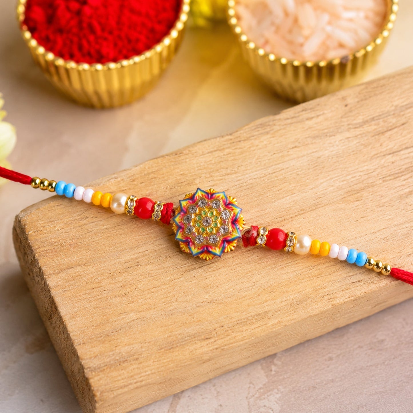 Top view of the designer Rangoli Mandala rakhi with pearl beads