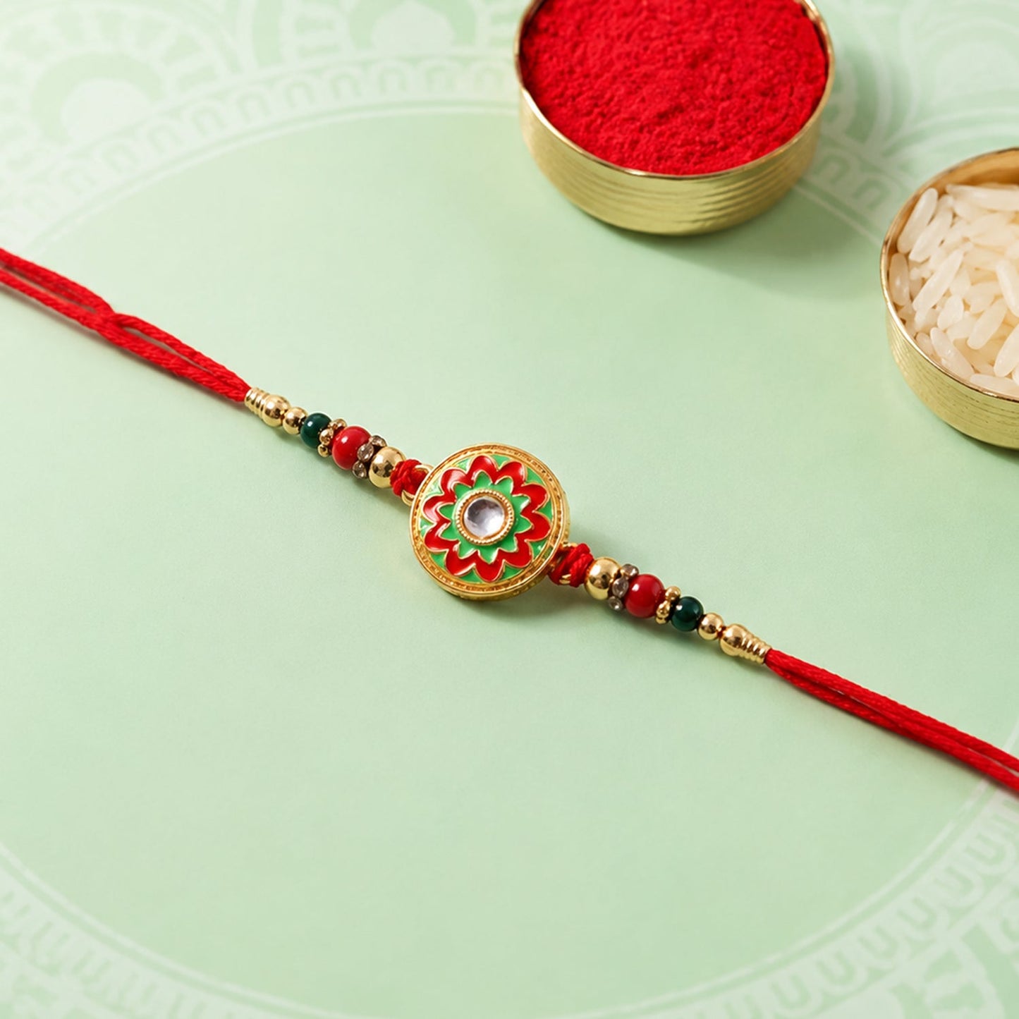 Side angle of colorful Meena flower round charm rakhi with beads