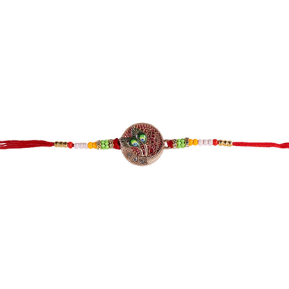 Beaded rakhi with peacock feather charm tied on wrist