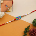 Rakhi – Colorful Beaded Rakhi with Peacock Charm for Brother