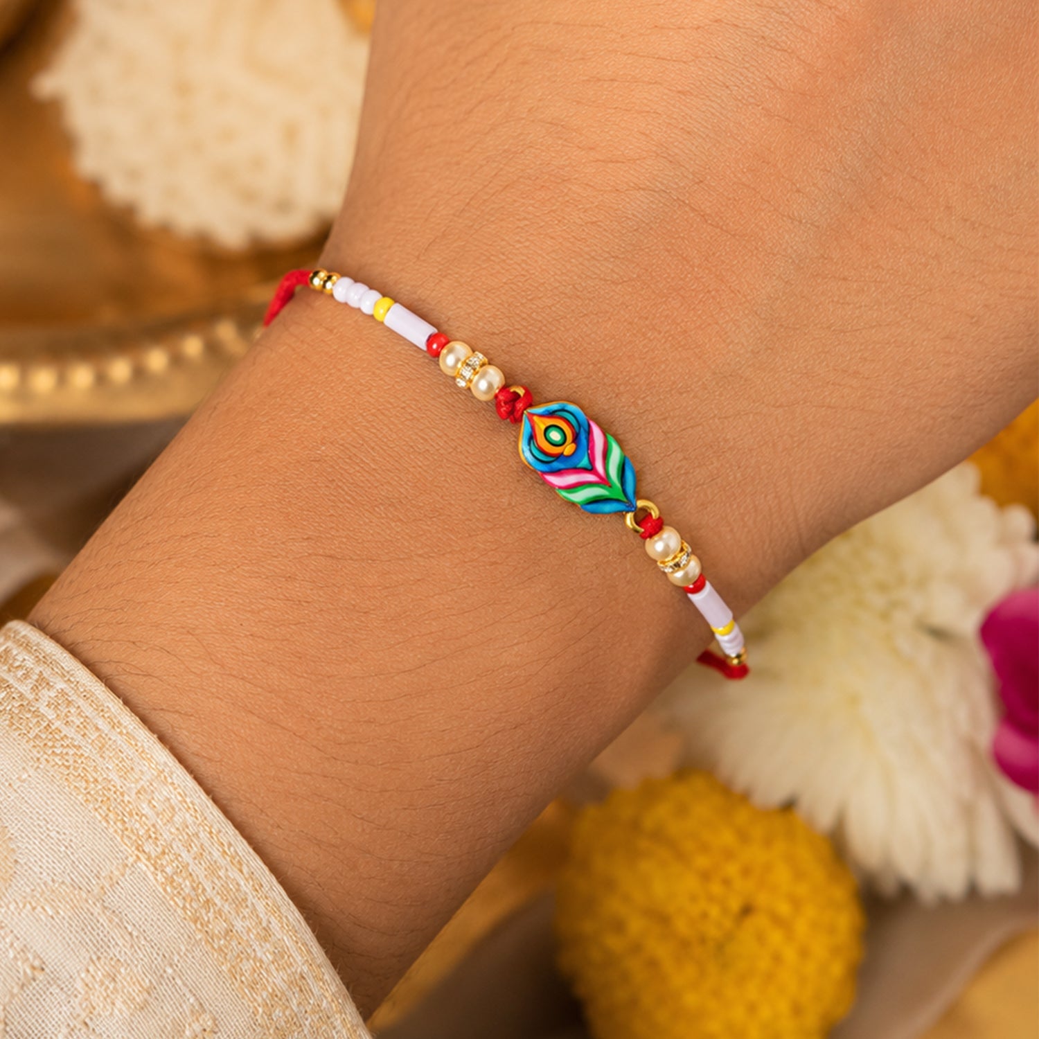 Designer rakhi close-up with vibrant beads and peacock feather