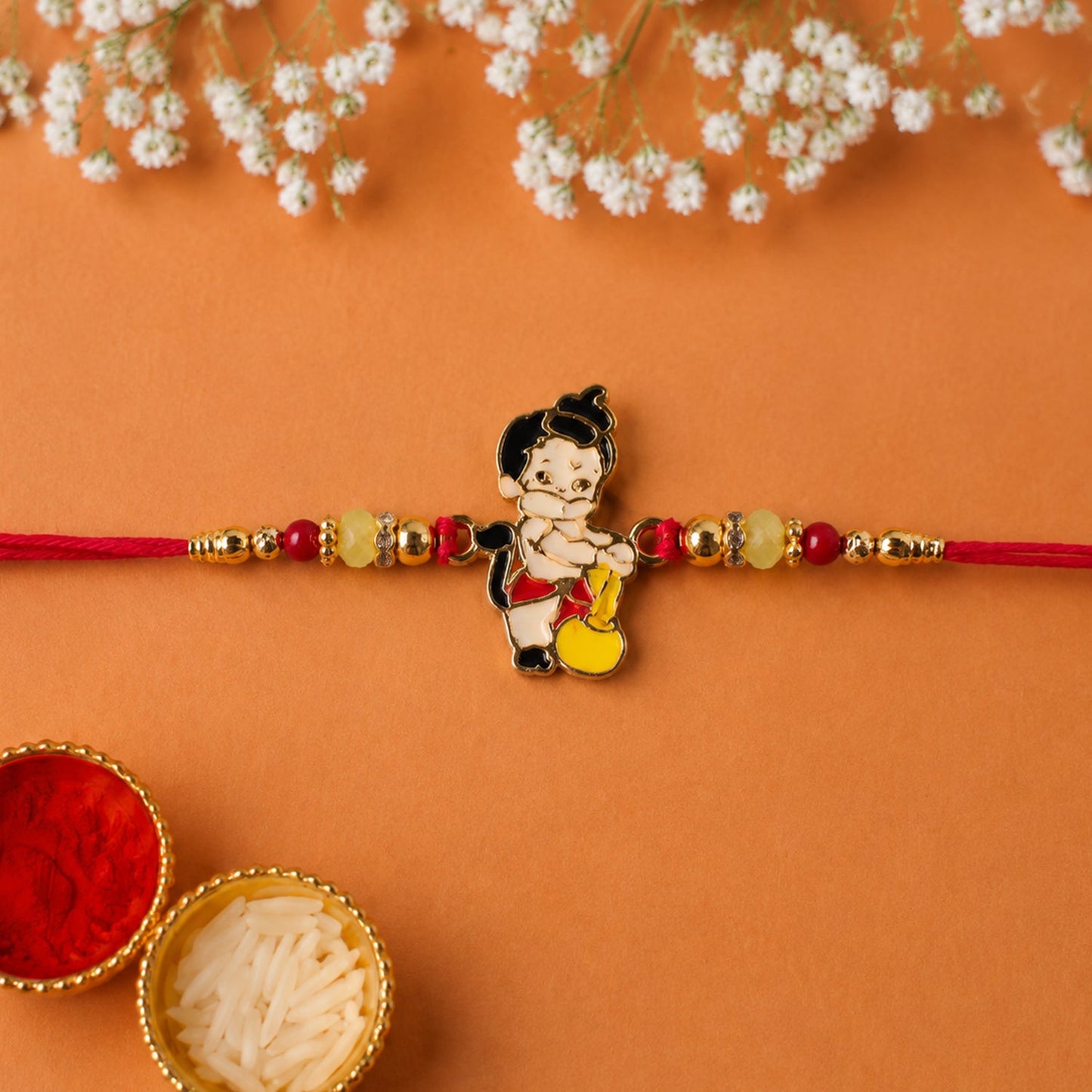 Top view of stylish Bal Hanuman rakhi bead with Gada charm