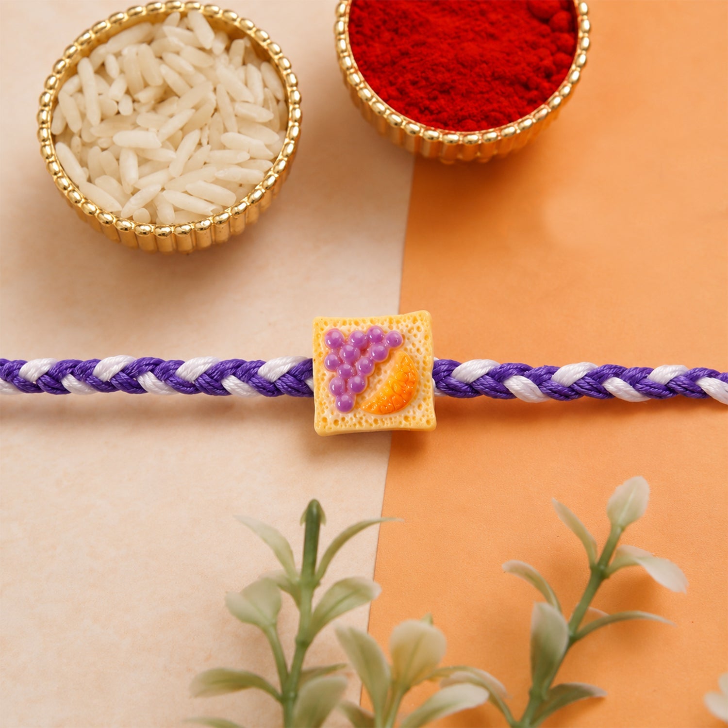Close-up of Cute Fruit Toast Charm on braided rajhi thread