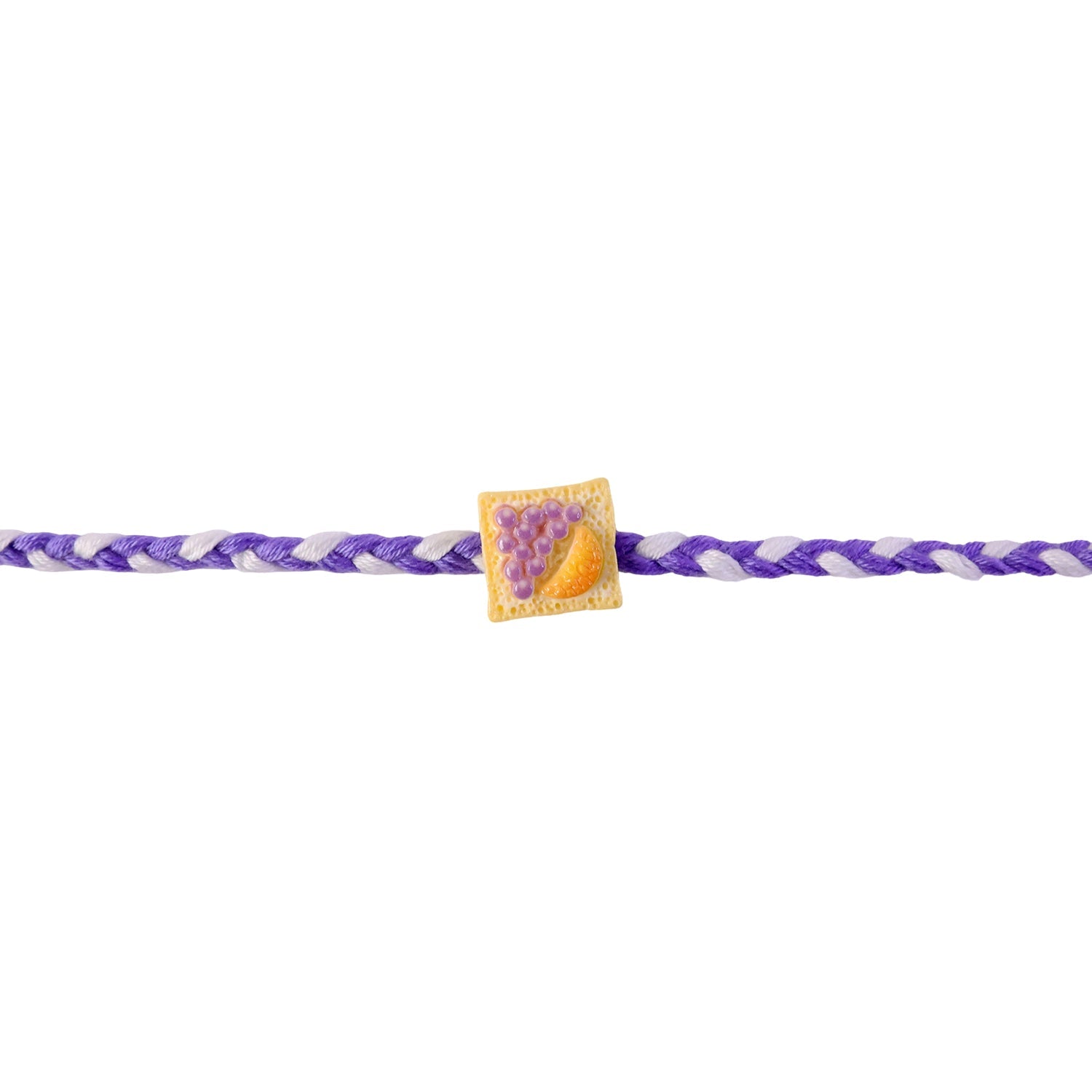 Colorful braided rakhi with fruit toast charm detail