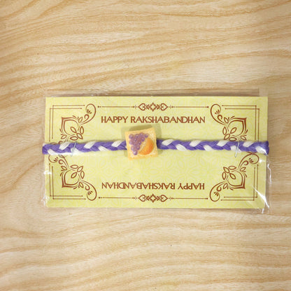 Decorative Fruit Toast Charm Rakhi with braided thread close up