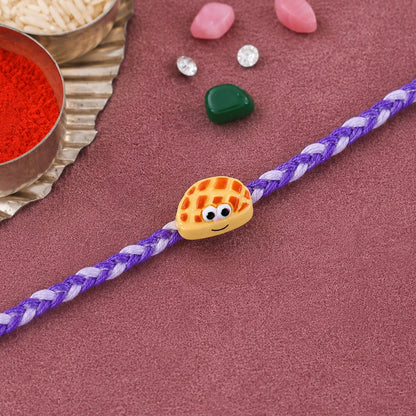 Close-up of Smiley Waffle Charm detail on Rakhi