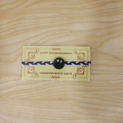 Full view of Funny Cookie Eyes Braided Thread Rakhi on white background