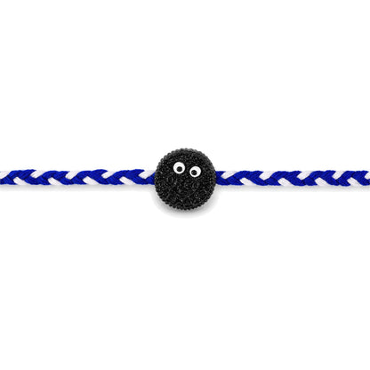 Close-up of braided rakhi with funny cookie eyes charm