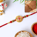 Golden Swastik Rakhi – Elegant Beaded Festive Thread