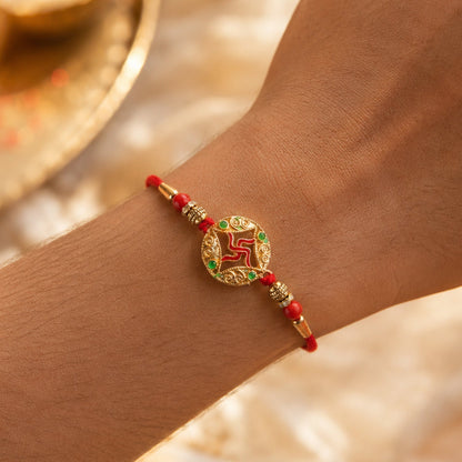 Top view of golden swastik charm rakhi with beads