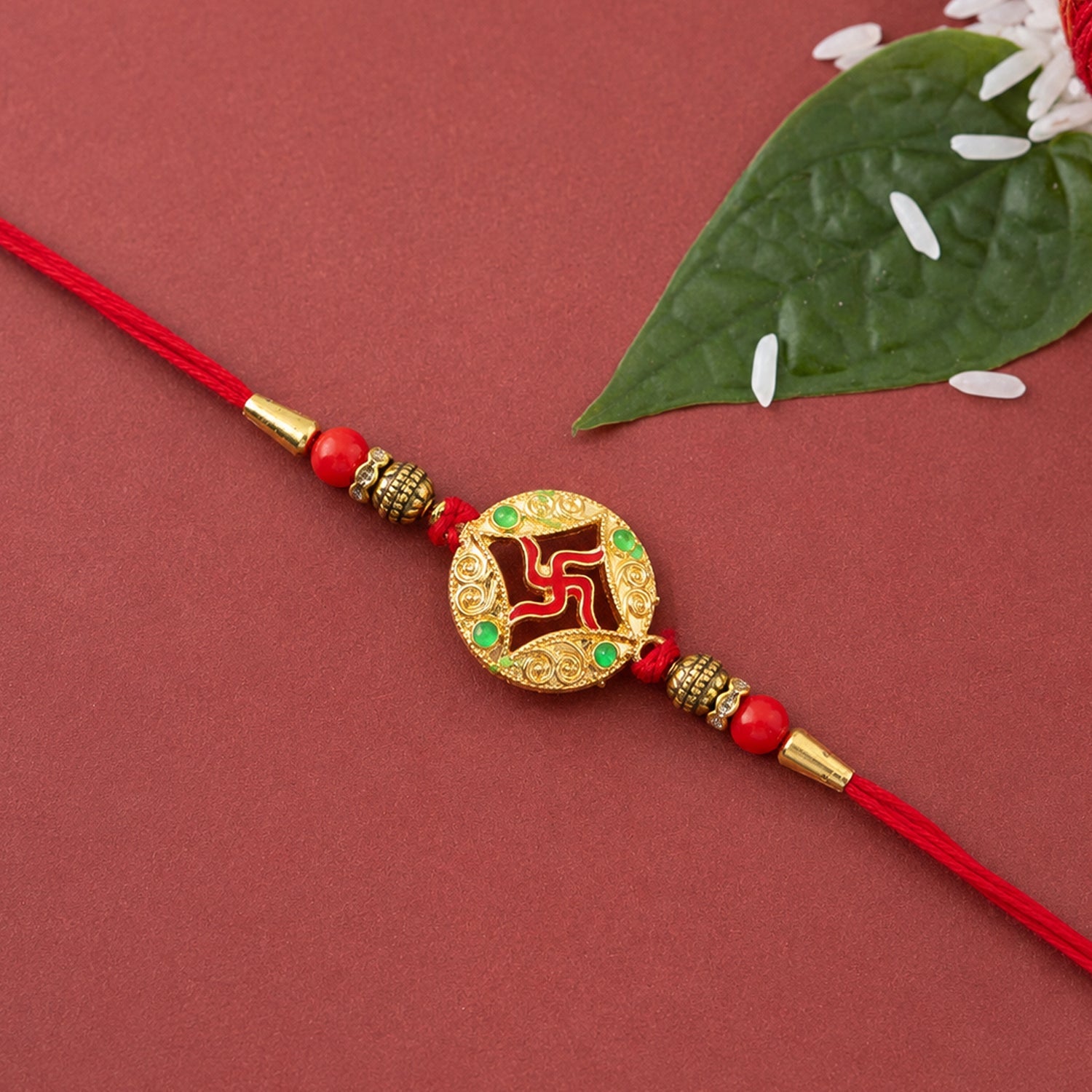 Golden charm rakhi tied with colorful threads