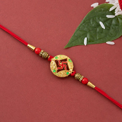 Golden charm rakhi tied with colorful threads