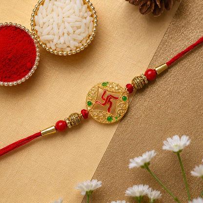 Designer beaded rakhi with golden swastik charm seen from side angle