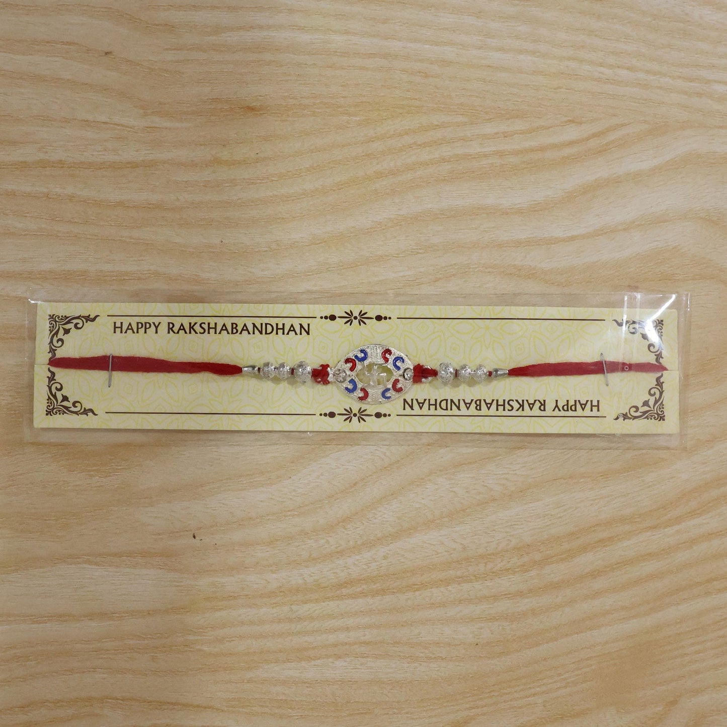 Packaging of Silver Swastik Meena Charm Rakhi