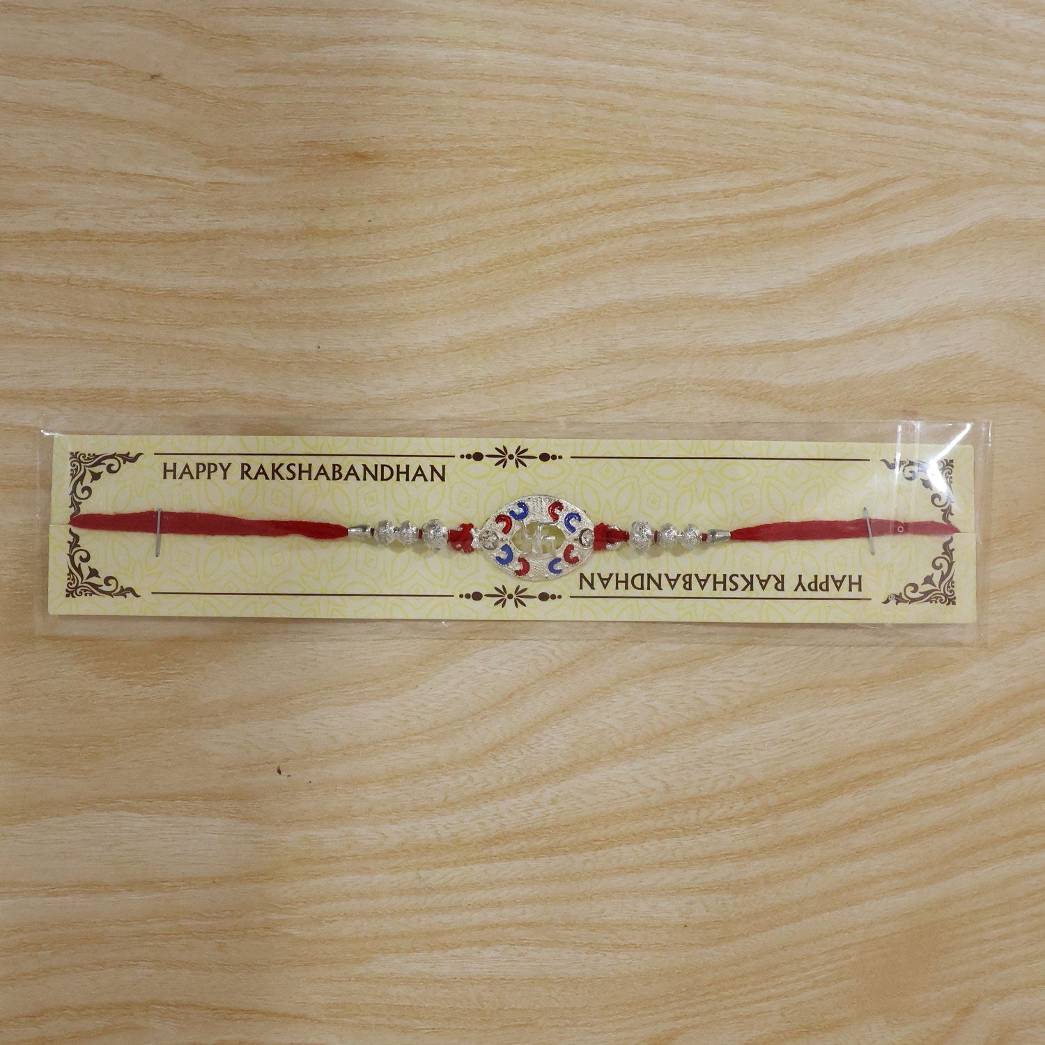 Packaging of Silver Swastik Meena Charm Rakhi