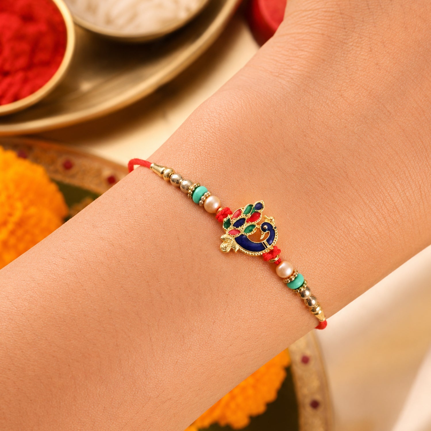 Designer Meenakari Peacock Charm Rakhi close-up