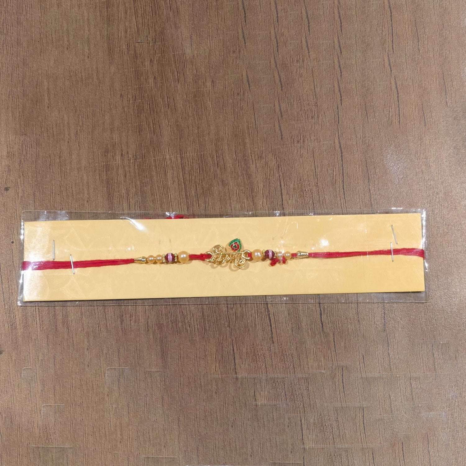 Full view of Krishna Mor Pankh Pearl Beads Rakhi with tying thread