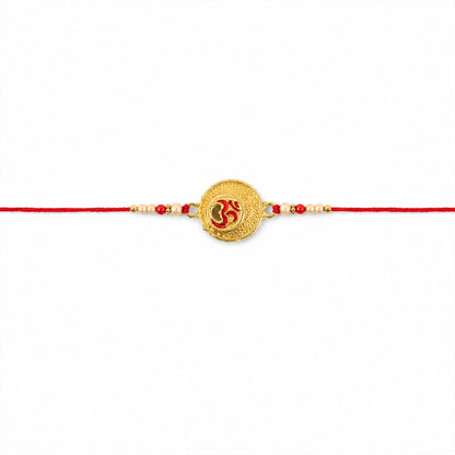 Close-up of pearl beads and engraved Om coin charm rakhi