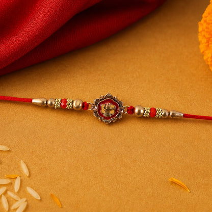 Close-up of floral charm detail on Rakhi