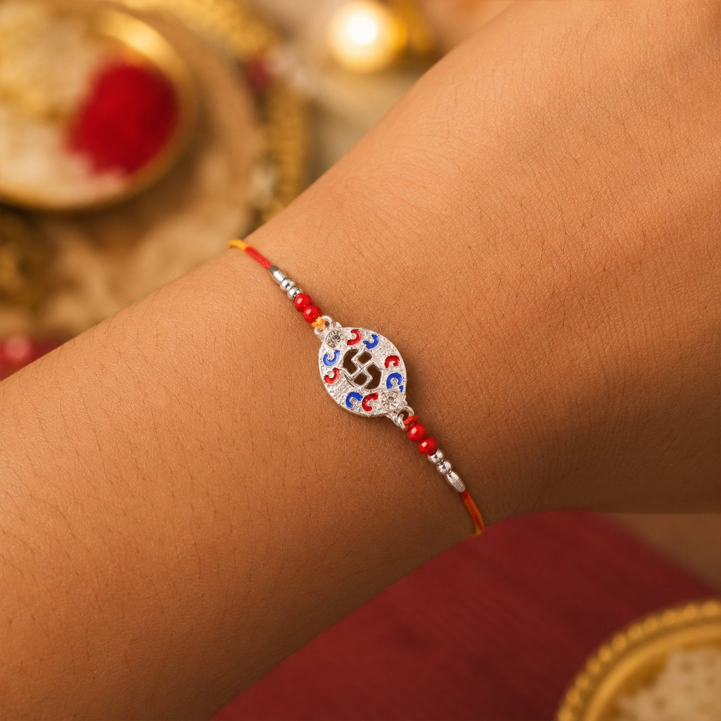 Silver Swastik Meena Oval Charm Rakhi with beads showing thread