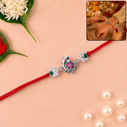 Silver Peacock Flower Heart Rakhi with dori close-up