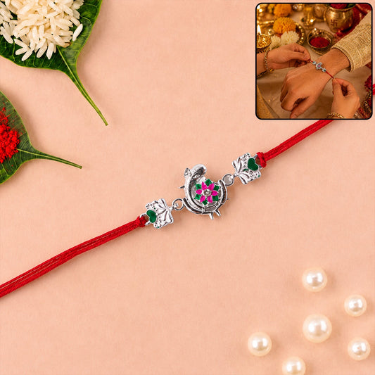 Silver Peacock Flower Heart Rakhi with dori close-up