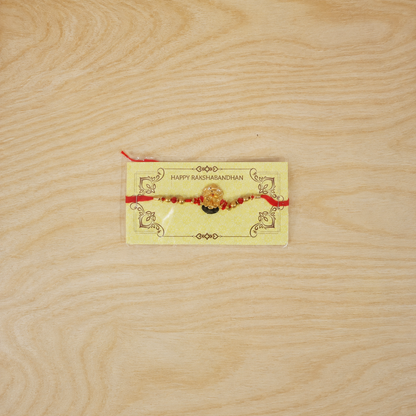 Golden Divine Face Charm Rakhi with pearl beads - top view