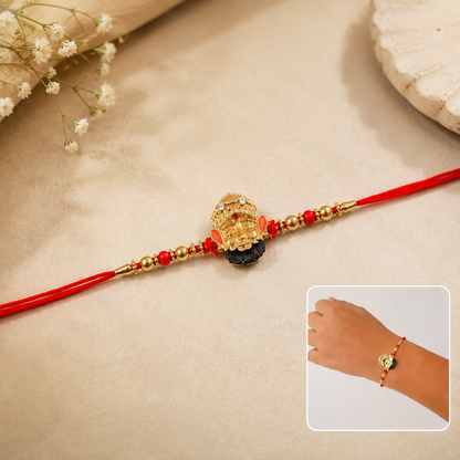 Close-up of pearl bead details on Golden Divine Face Charm Rakhi