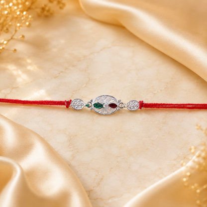 Silver Oval Floral Stone Rakhi with dori laid flat
