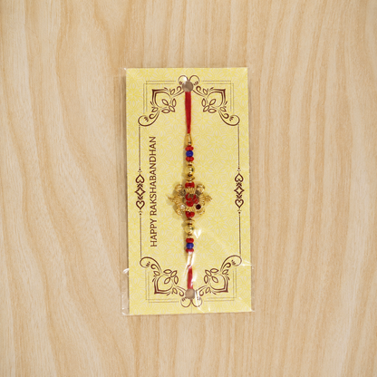Full length Golden Tortoise Om Meena beaded rakhi string