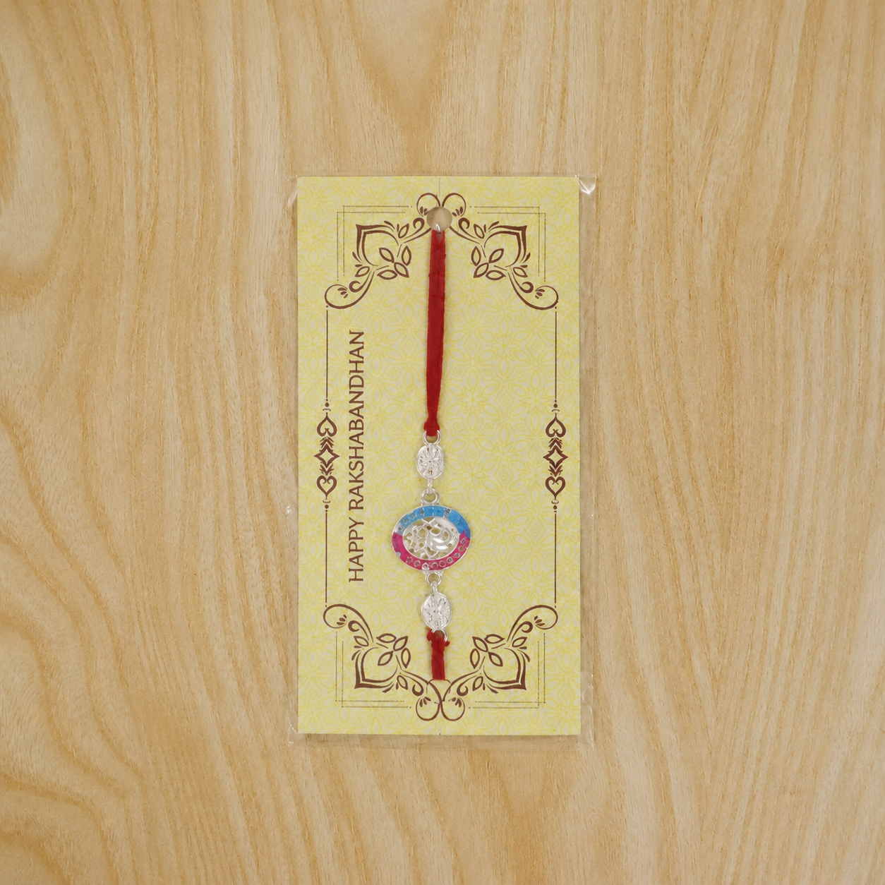 Top view of silver round stone rakhi with neat finishing