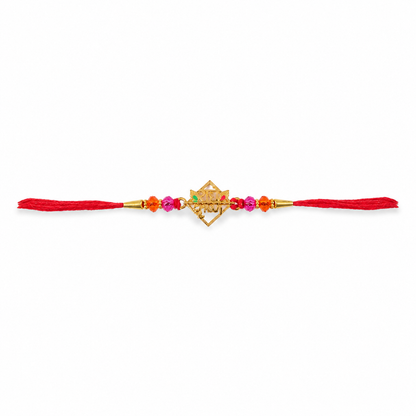 Side angle of golden Radha Krishna rakhi with crystal embellishments