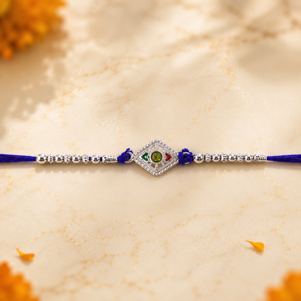 Close-up of silver kite stone charm Rakhi with beads detail