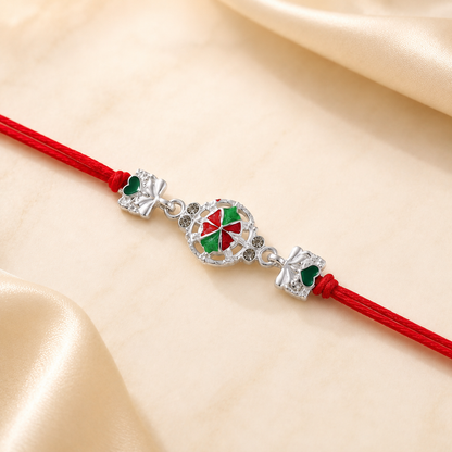Close-up of silver pinwheel flower charm rakhi